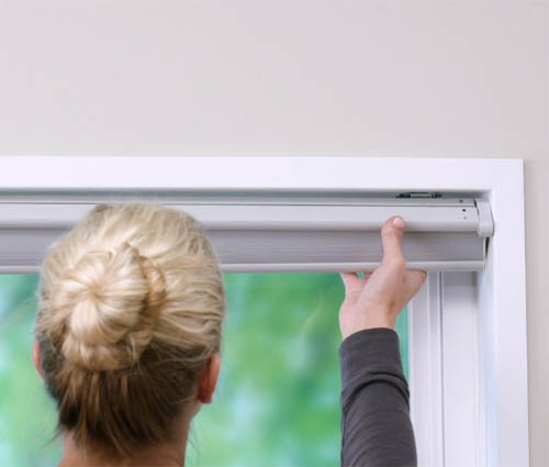 Unclipping window shade from brackets