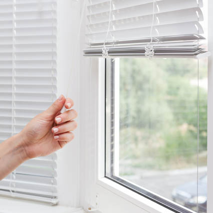Lowering a venetian blind with cord