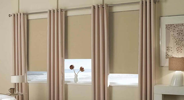 Roller shades in a bedroom