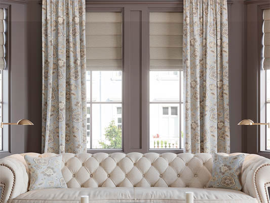 Roman shade layered with curtains