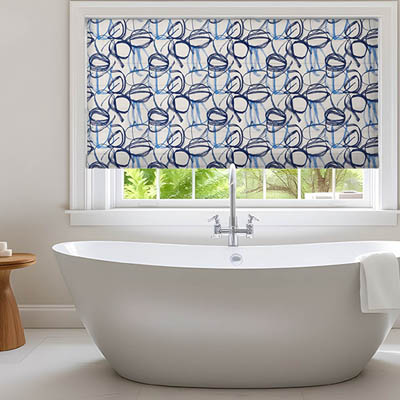 Patterned roman shade in a bathroom